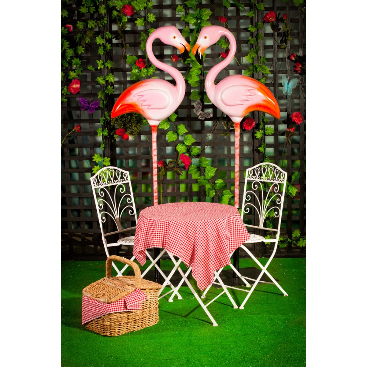 Flamingo on pole with wrought iron garden furniture